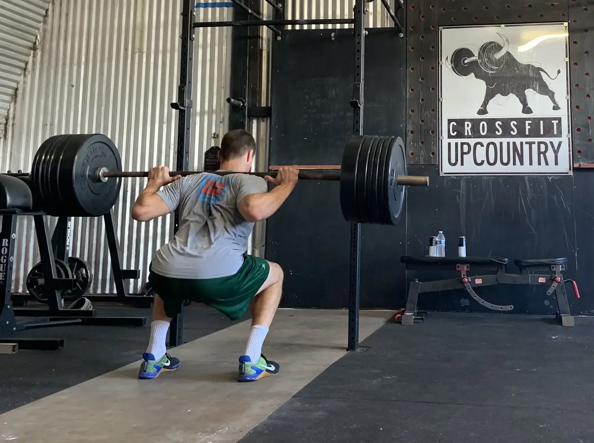 Athlete performing a barbell back squat at a gym in Makawao, Upcountry Maui